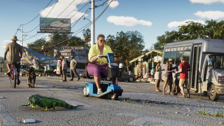 A Keys street with a woman on a mobility scooter and an iguana crossing the road