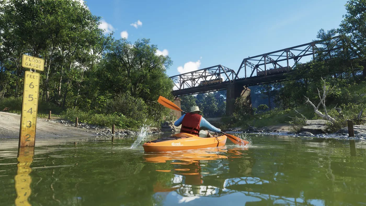 A kayaker on a river under a train bridge in Mount Kalaga backwoods