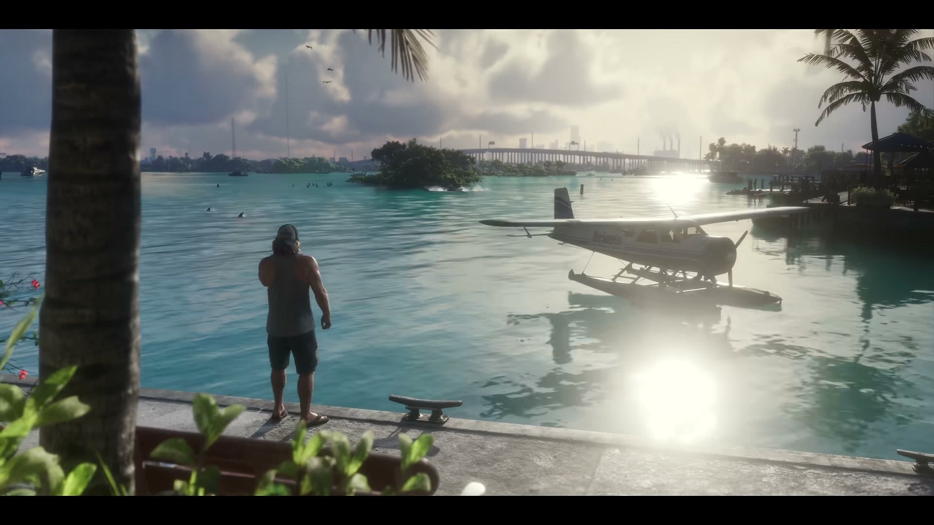 Birds flying over a marina in the GTA VI Launch Trailer, with a man on a dock and a seaplane