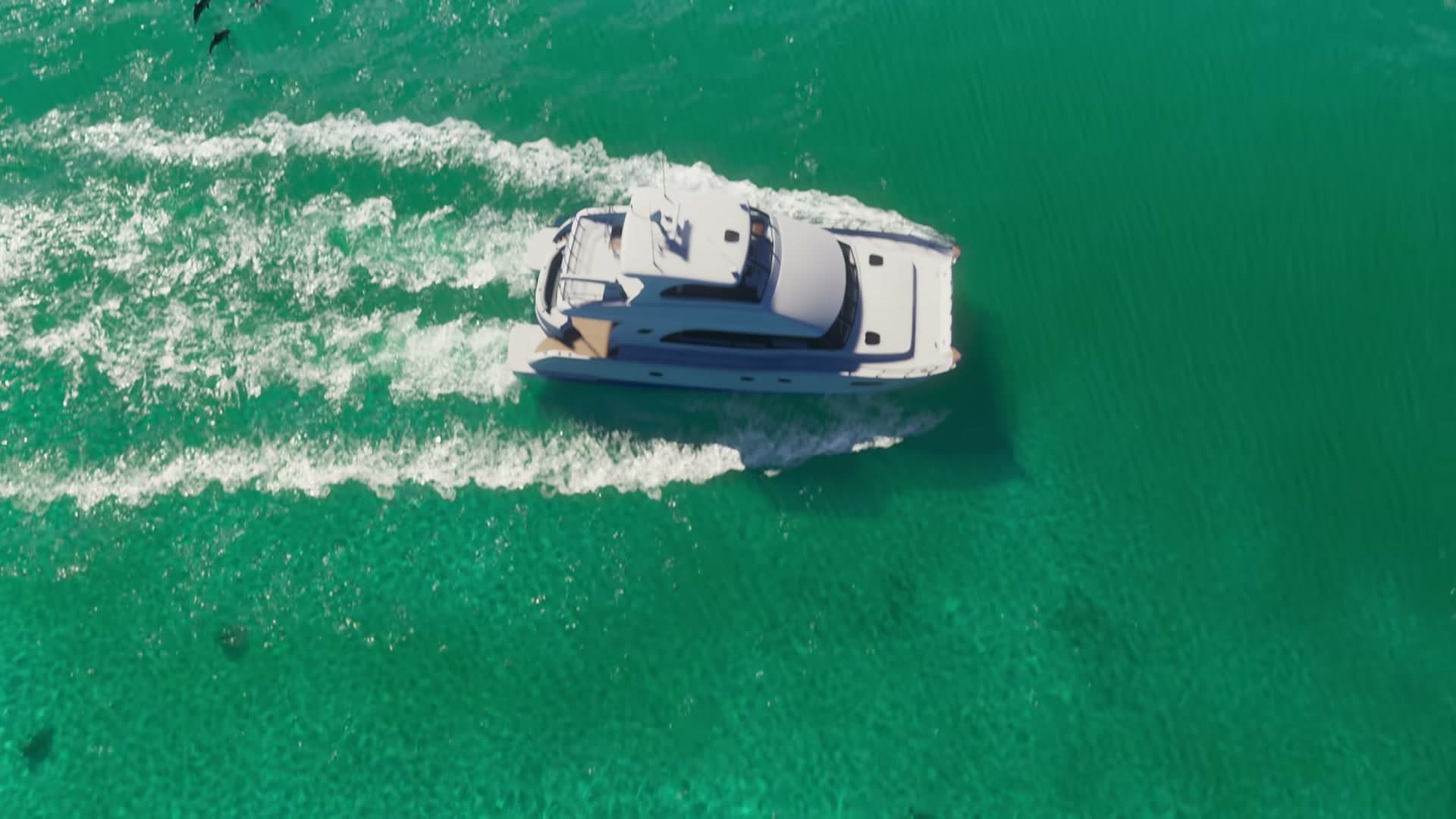 Dark marine shapes in the water near a yacht in GTA VI Trailer 1